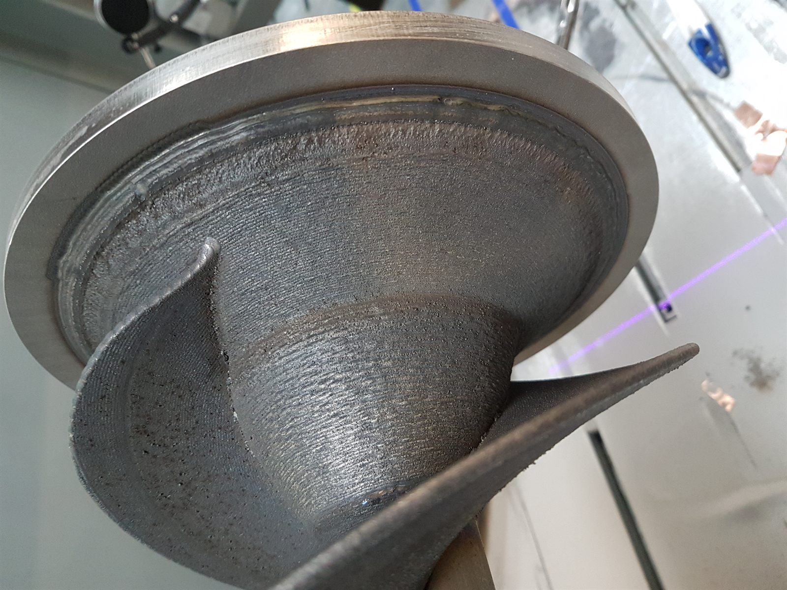 Close view of the connection between helical blade structure and cone region on a metal impeller prototype