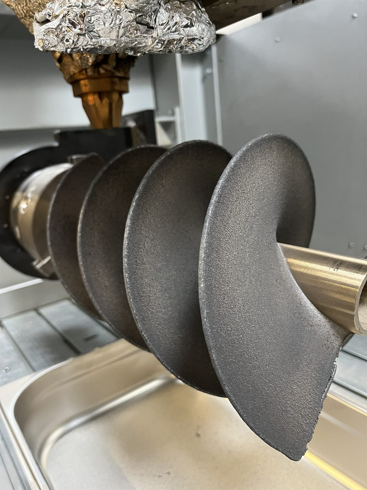 Front view of a metal 3D printed helical impeller prototype showing repeated helical blades