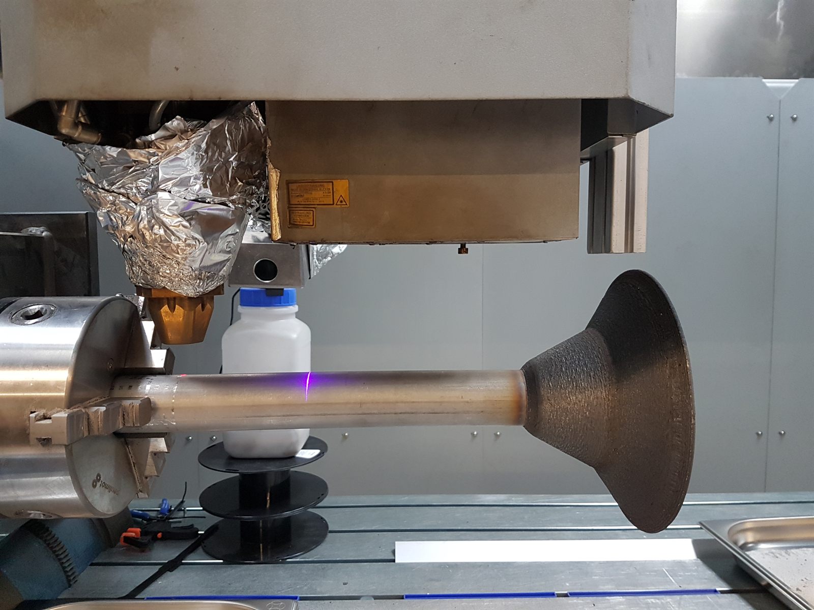 Detail view of the spray-cone region and central shaft relationship on a metal 3D printed impeller prototype