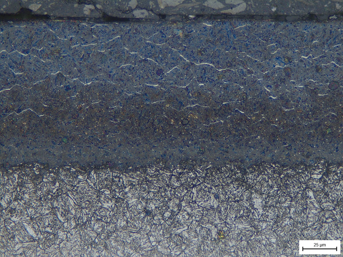 Metallographic cross-section of an LMD hardfacing layer with scale bar