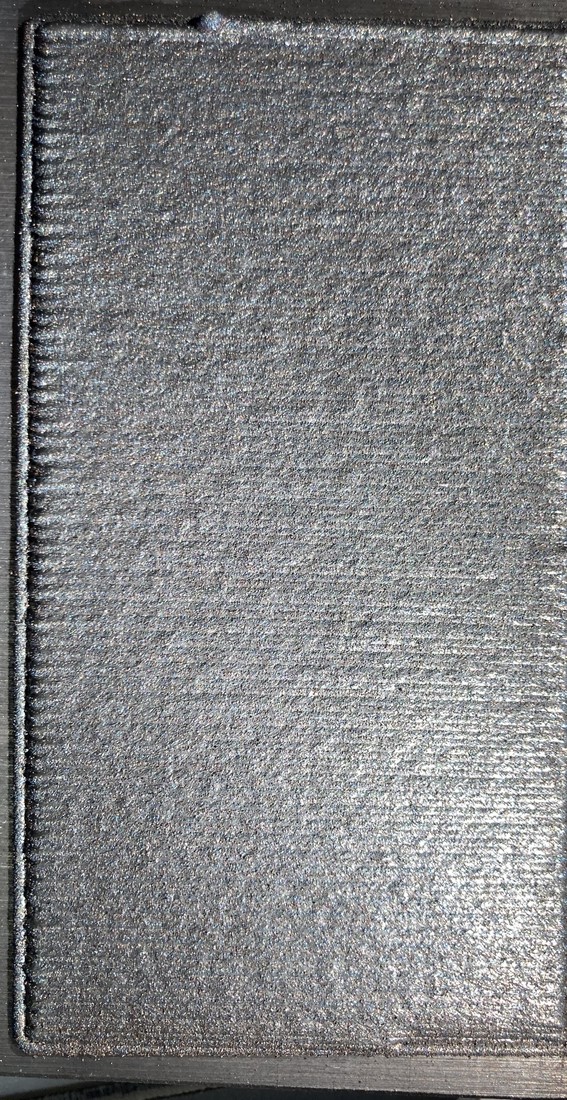 Close-up of a tungsten-carbide-containing LMD hardfacing surface